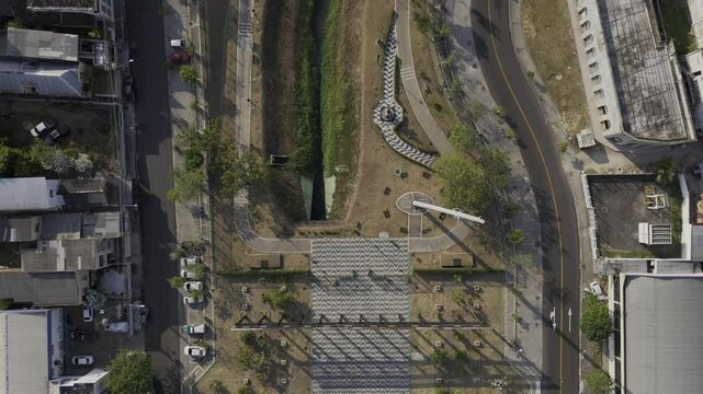 Drone flies forward with camera pointing down over southern entrance to Parque Senador Jefferson Peres in Manaus, Amazonas, Brazil