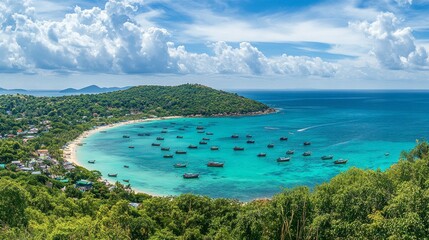 Fototapeta premium A panoramic view from a hilltop on Koh Larn, showcasing the turquoise waters and the small boats anchored near the islands shoreline.