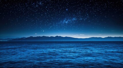 Ocean water reflecting light of stars in night sky background