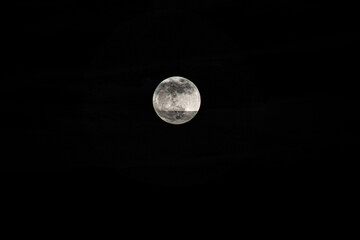 Full moon in the dark sky, can be used as a background