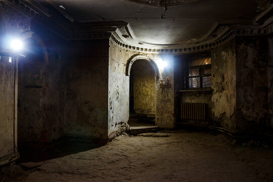 Gloomy shabby underground floor of an old mansion illuminated by weak light