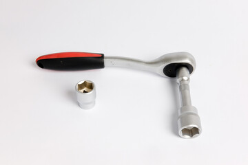 Preset torque wrench ratchet with cap heads. Handle covered in red and black. Work tool with reversible ratchets for screw and nut tighten, design element. Isolated on a white background