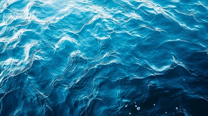 Obraz premium A serene view of shimmering blue water, capturing the gentle waves and reflections in a tranquil aquatic setting.