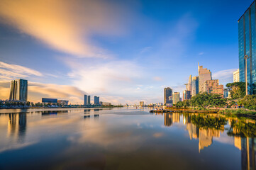 Fototapeta premium Sunrise landscape in Ho Chi Minh City, Vietnam with tall buildings located along the Saigon River. This is the largest city in Vietnam and is located in the south of the country.
