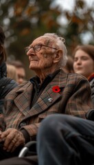 Fototapeta premium Elderly Veteran with Family at Remembrance Day Event, Wearing Poppy, Reflecting on War Memories