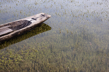 Beautiful landscape during the rainy season of Myanmar, a small wooden boat floats in the middle of...
