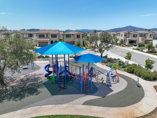 Colorful children playground activities in community public park Children run, slide, swing on modern playground. 