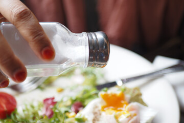 Salt falls from a salt shaker 