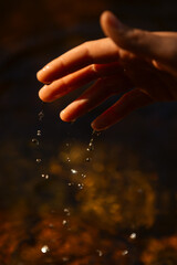 Droplets of water falling from a hand.