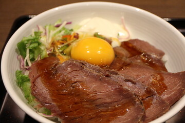 Japanese cuisine: ostrich meat bowl with raw egg in Tokyo, Japan