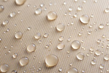 Water droplets on beige fabric close-up