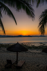 Beach daybed and the palm trees at Dadonghai beach, Sanya, China
