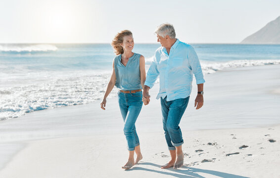 Love, holding hands and walking with old couple at beach for travel destination, summer and anniversary vacation. Relax, tropical and retirement with senior people for holiday, bonding and romance