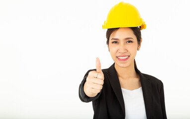 Portrait Pretty Asian Architect Woman with black suit and yellow safety helmet show her thumbs up in approval, give permission, recommend construction company,  isolated over white background