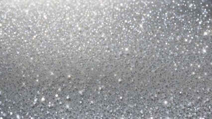 Glittery snow background, shimmering silver glitter over a soft white snow-like texture, sparkling and festive