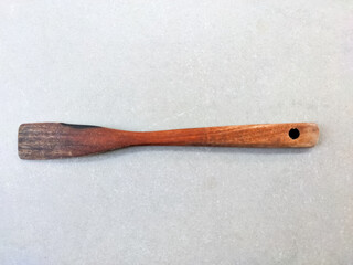 In this close-up, a wooden spatula reveals its natural grain, the smooth texture of the wood...
