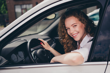 Photo of good mood positive woman wear white shirt driving auto going shopping outdoors urban city...