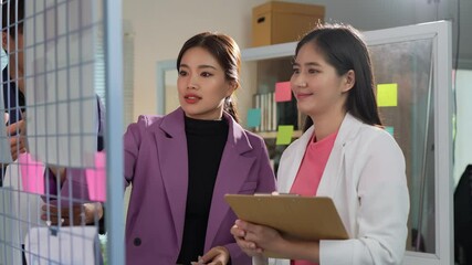 Asian businessman and businesswoman meeting, meeting in modern office, teamwork concept, data presentation on laptop, tablet with documents, graphs, charts, analysis, startup business idea concept.