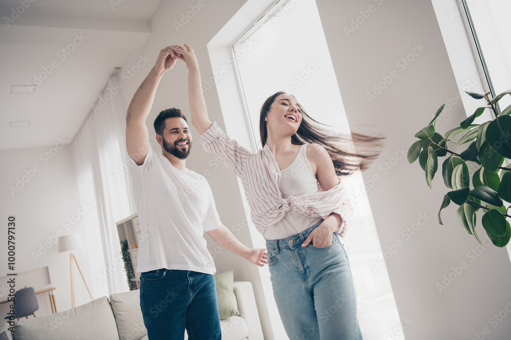 Poster Portrait of two nice young people dancing spin bright interior free time apartment indoors