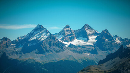 Fototapeta premium Snow-Covered Mountain Peaks Under a Clear Blue Sky