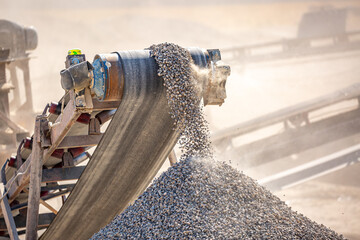 Crushing stones in a quarry for processing minerals, cement, limestone. Distribution and Screening Plant Gravel. Vibrating screen stone crusher in operation.