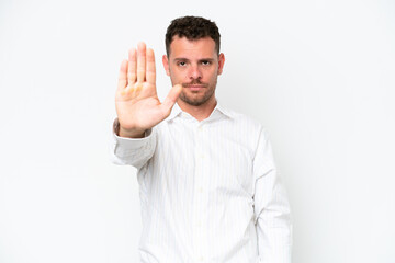 Fototapeta premium Young caucasian handsome man isolated on white background making stop gesture