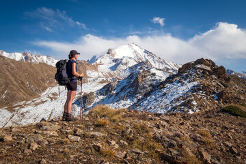 Young hiker backpacker woman on a top of a mountain in Kazakhstan