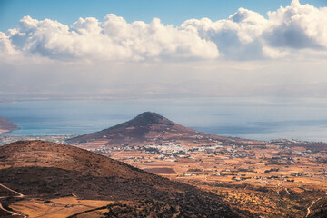 Fototapeta premium Scenic view of coastal landscape and distant village, Paros island, Greece