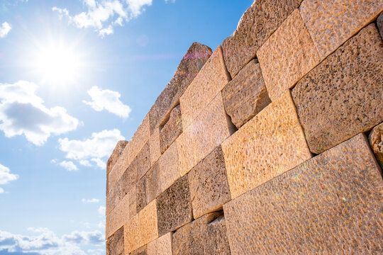 Architectural deail of ancient stone walls with sun and sky background, Temple of Demeter, Naxos, Greece