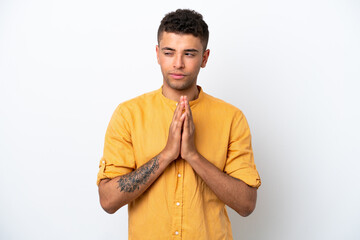 Young caucasian Brazilian man isolated on white background scheming something