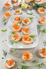 Toasts with cream cheese and smoked salmon. Ideal for festive catering and buffet food presentations