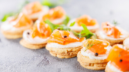 Close-up of canapés with cream cheese and smoked salmon. Perfect for festive catering and gourmet appetizers