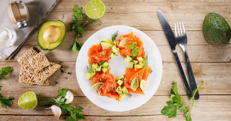 Plate of smoked salmon salad with avocado, and lettuce. Ideal for fresh, healthy, and light meals, festive food