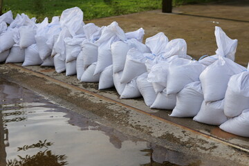 Sandbag for flood protection. A pile or wall of sandbags at the front entrance of a house to keep flooding water out of the residence, and separate wet and dry zone