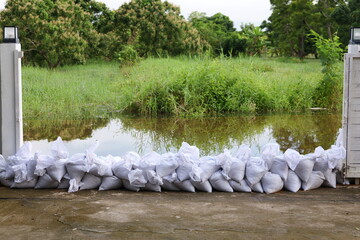 Sandbag for flood protection. A pile or wall of sandbags at the front gate or entrance of a house...