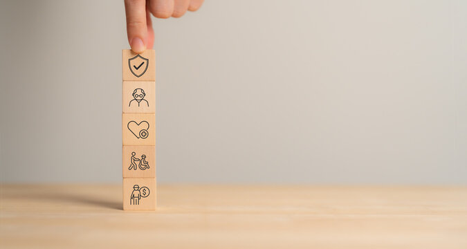 Retirement planning and insurance concept. Elderly health insurance. A stack of wooden blocks,  representing senior care, health, disability support and financial security and management.