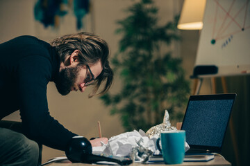 A paranoid makes notes or calculations on sheets in search of answers to pseudoscientific...