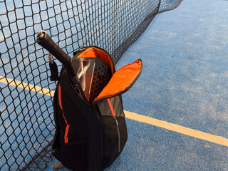 padle racket and bag on the court