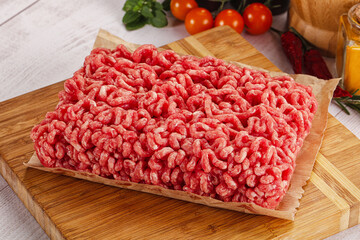 Raw minced beef meat over board