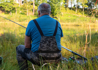 beautiful landscape with a small forest lake, fisherman on the shore of the lake, various fishing...