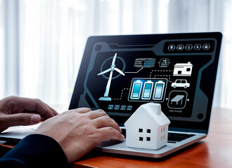 Smart home, power your home with renewable energy concept. Renewable energy data system and management control display and white small house on laptop computer while person monitor on screen at home.