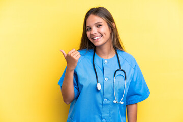 Young nurse caucasian woman isolated on yellow background pointing to the side to present a product