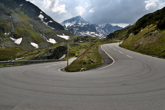 Winding road of Fl&uuml;ela Pass offering breathtaking views of the Swiss Alps and connecting Davos with Susch amidst scenic mountains