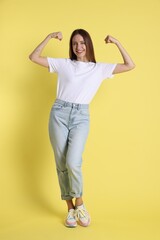 Fototapeta premium Portrait of happy winner on yellow background