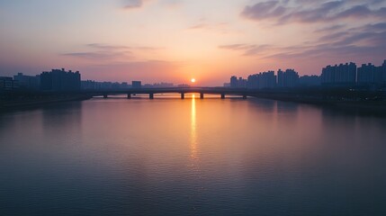 Obraz premium A city skyline at sunset, with a bridge in the foreground.