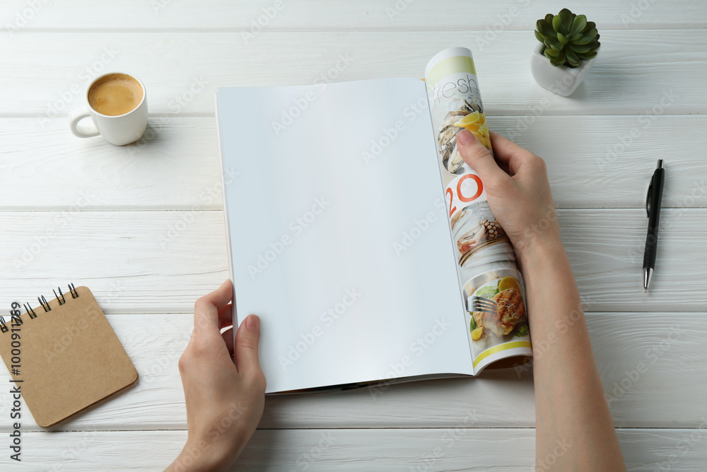 Sticker Woman reading magazine at white wooden table, top view. Mockup for design