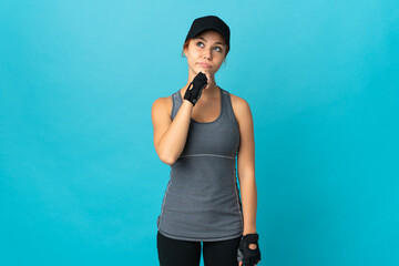 Teenager sport russian girl isolated on blue background and looking up