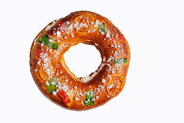 Roscon de reyes, a sweet dough ring decorated with candied fruit and filled with cream. Elevated view.