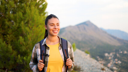Beautiful, young woman enjoying hiking on the mountain