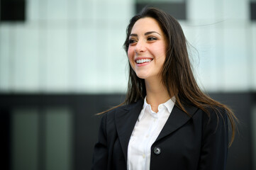 Confident young female manager outdoor in a modern urban setting